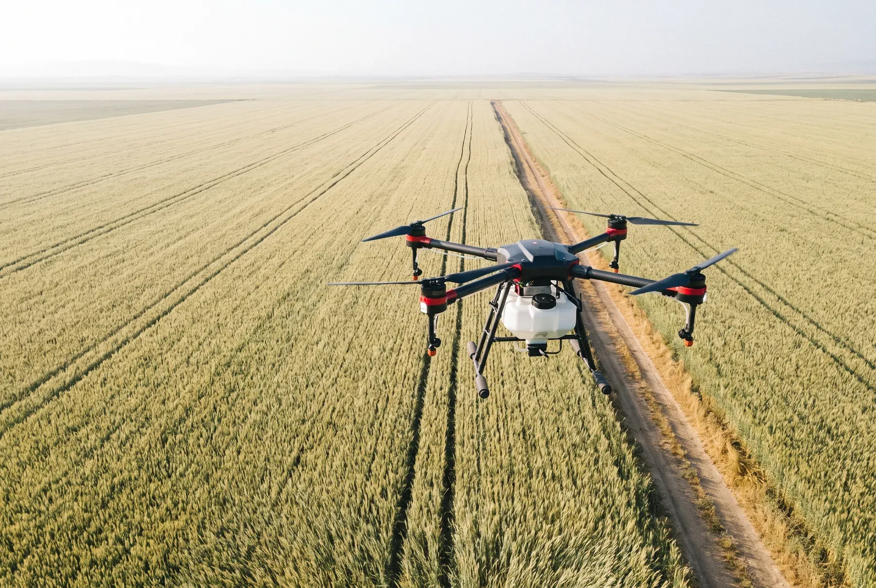 An agricultural drone working over a wide grain field